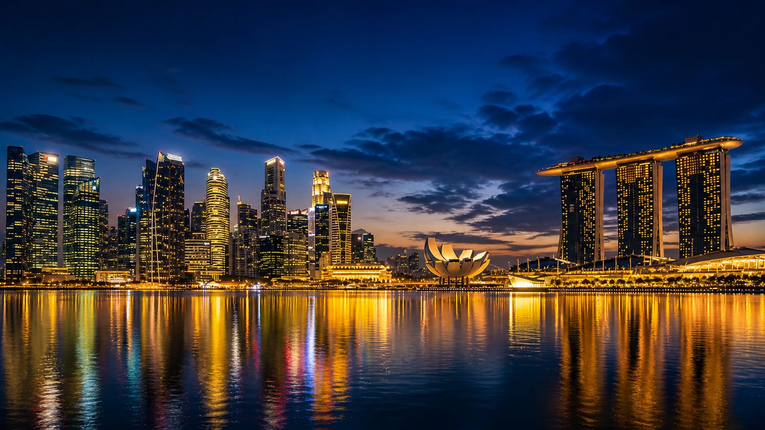 Singapore Marina Bay skyline at twilight with Marina Bay Sands and CBD reflected in the water